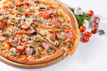 Italian kitchen and cooking concept. Hot tasty sliced with ham, sausage, jalapenos, mushrooms, tomato. Eat delivery concept.