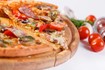 Italian kitchen and cooking concept. Hot tasty sliced with ham, sausage, jalapenos, mushrooms, tomato. Eat delivery concept.