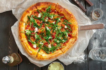 delicious italian pizza served on wooden table top view