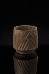 Wooden glass on a black background with reflection