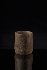 Wooden glass on a black background with reflection