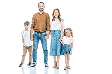 Obraz premium full length view of happy family with two kids standing together and smiling at camera isolated on white