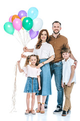 happy family with two kids holding colorful balloons and smiling at camera isolated on white
