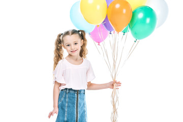 adorable little child holding colorful balloons and smiling at camera isolated on white