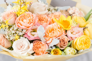 beautiful bouquet of flowers set on wooden table. the work of the florist at a flower shop. A small family business. Horizontal photo