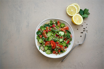 Quinoa tabule salad. Cucumbers, bell peppers, tomatoes, parsley, onions, mint ingredients
