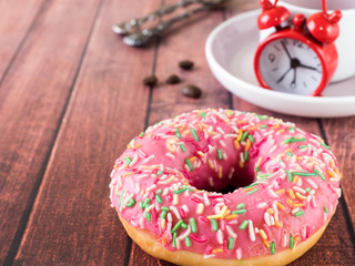 Donuts and coffee on wooden table. Top view with copy space