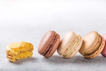 French assorted macarons on light gray concrete background. Holidays food concept with copy space.