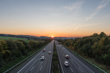 The road traffic on a motorway at sunset