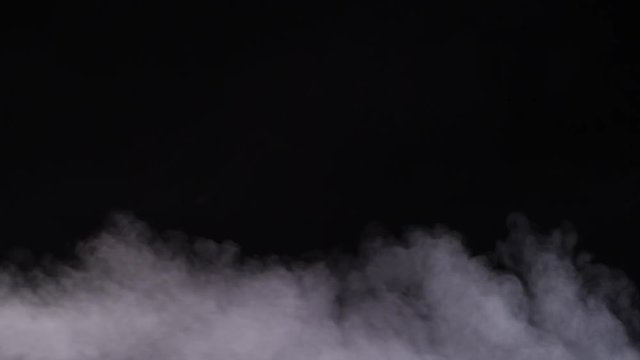 Slow moving smoke on black background