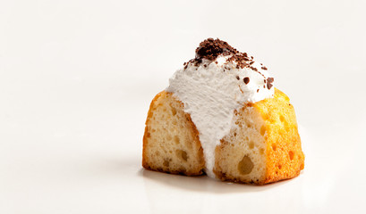 One cupcake stuffed with white cream cut in half, isolated on white background. The image with copy space.