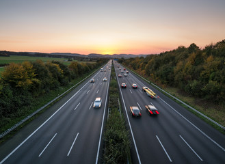 The road traffic on a motorway at sunset