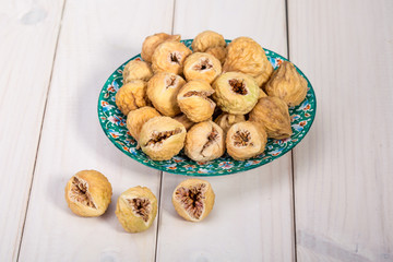 Close Up Of Premium Sun Dried Delicious Mini Whole Figs In Round Shape On A White Wooden Table Perfect Healthy Sweet Snack Or On A Cheese Board, For Baking, Cereals Or Desserts