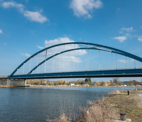 Large blue bridge in front of blue sky at the harbor