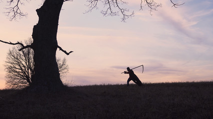 Fototapeta na wymiar Grim Reaper sunset silhouette. concept of death