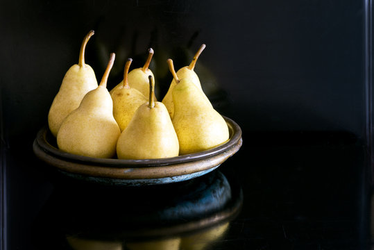 Several yellow pears on a plate