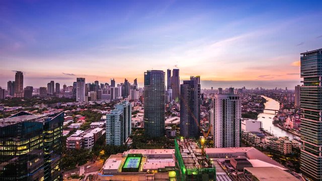 Manila, Philippines, Day to Night Time Lapse View Showing Makati City and Pasig River at Sunset