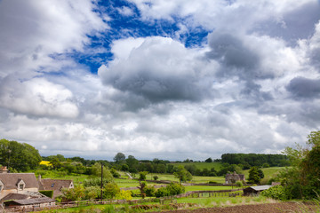 English rural landscape with dramatic sky over small village Southern England UK