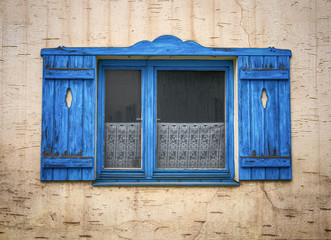Old blue and wooden window with shutters