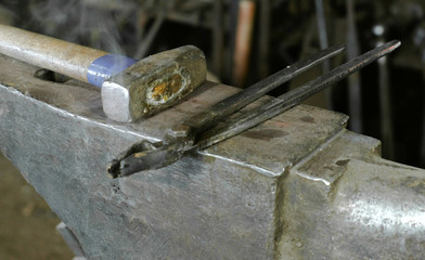 Hammer on anvil in the blacksmith's shop.