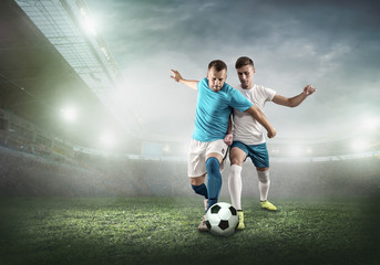 Soccer player on a football field in dynamic action at summer 