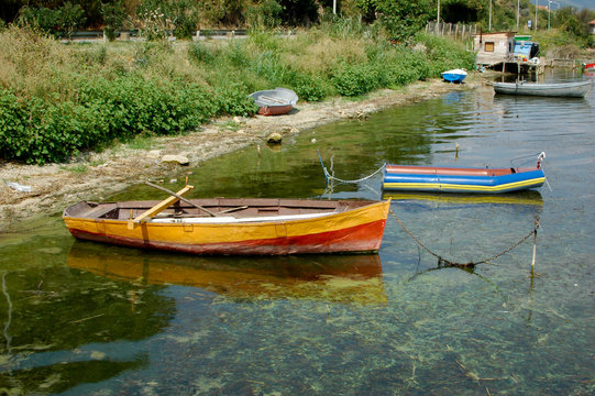 old colorful wooden fish boats on lake shore with reed, Lake Dojran, Macedonia