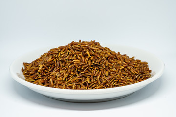 Brown rice white isolated. The whole grain rice, the inedible outer hull removed; white rice is the same, bran layer and cereal germ removed. Red rice, gold rice, and black rice are all whole rices