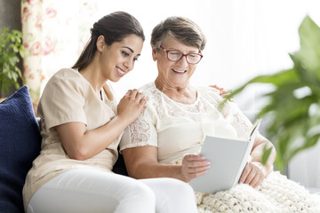Senior woman with nurse reading