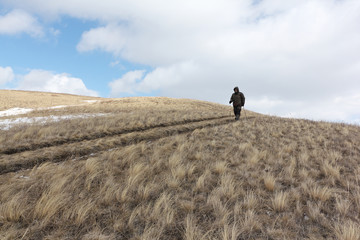 Nordic Walking -  adult man descending from the mountain Bald, Bugotaksky hills, Novosibirsk...