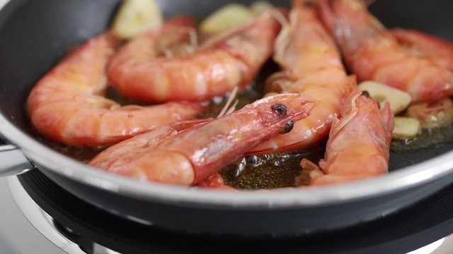 frying shrimps on frying pan