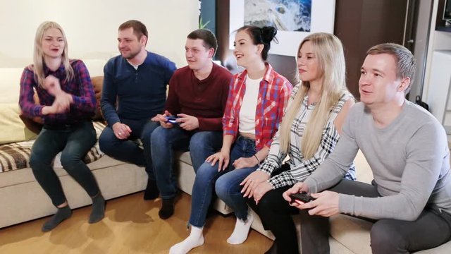 Happy group of friends playing video games
