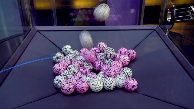 two Colour lottery balls in a sphere in motion. Gambling machine and equipment. Blurred lottery balls in a lotto machine.