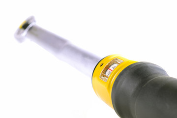 Torque wrench on the white background. Close up image, shallow depth of field.