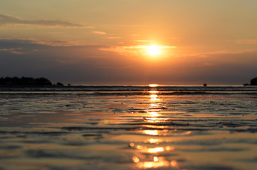 Fototapeta na wymiar The outfall on sand beach. Beautiful sunrise sky over Adriatic sea