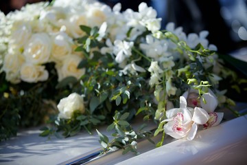 The composition from fresh flowers on the holiday car.