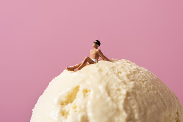 miniature man in swimsuit on an ice cream.