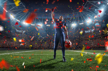 American football player emotionally rejoices in victory in professional sport stadium