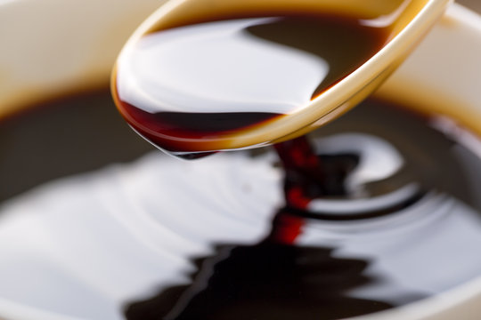 Closeup Of Soy Sauce Poured From A Spoon