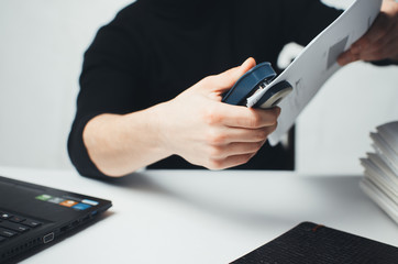 Close-up of female hand stapling the documents