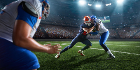 Naklejka premium American football players preforms an action play in professional sport stadium