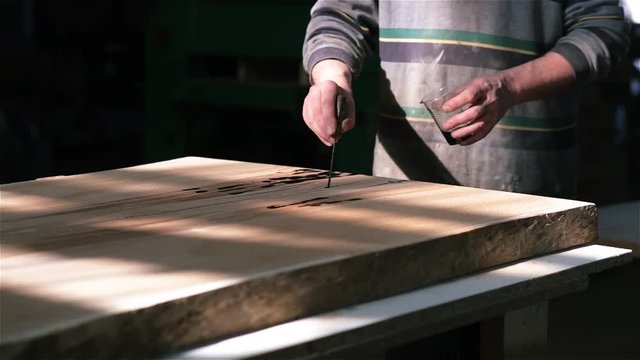 manufacture of exclusive furniture from solid wood. wood processing with epoxy resin, varnish. ancient technology.
