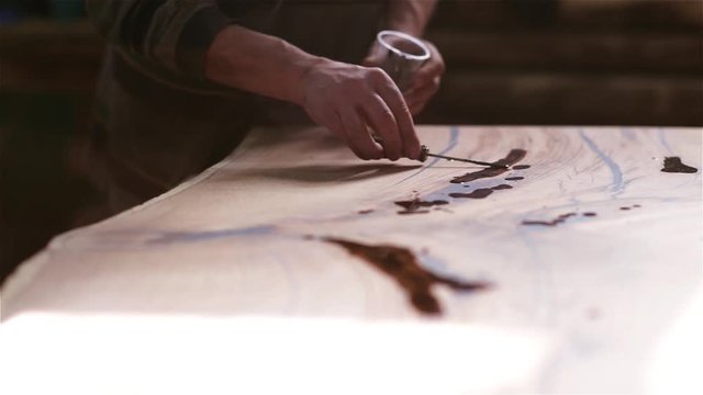 manufacture of exclusive furniture from solid wood. wood processing with epoxy resin, varnish. ancient technology.