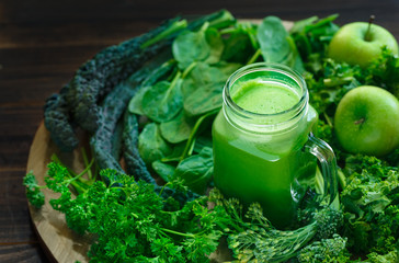 Variety of Organic Leafy Greens with a Glass Jar of Fresh Juice - obrazy, fototapety, plakaty