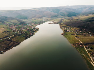 Aerial view of a rural village and lake in sunset.shot from above with drone