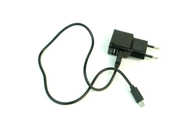 The charger for the phone. Photo on white background.