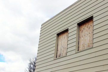 Boarded up windows of abandoned rural building