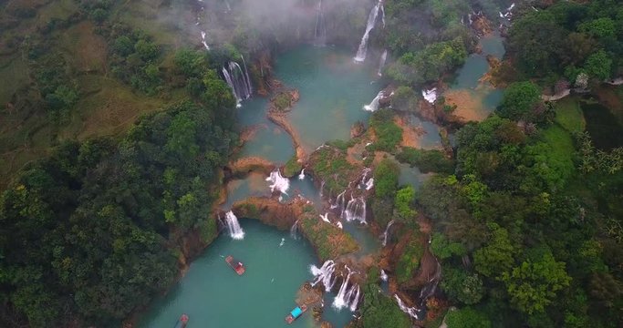 AERIAL 4K: over the Ban Gioc Waterfall at cloudy March  - the most magnificent waterfall in Vietnam