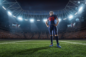 Obraz na płótnie Canvas American football player performs an action play on professional sport stadium