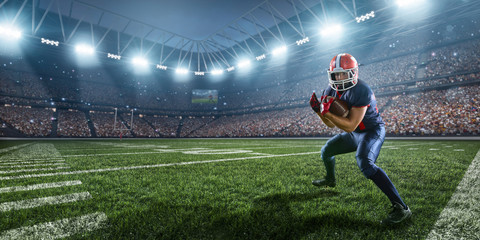 Obraz na płótnie Canvas American football player performs an action play on professional sport stadium