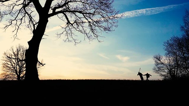 Grim Reaper came for a new victim and leads the victim to death. sunset silhouette. concept of death